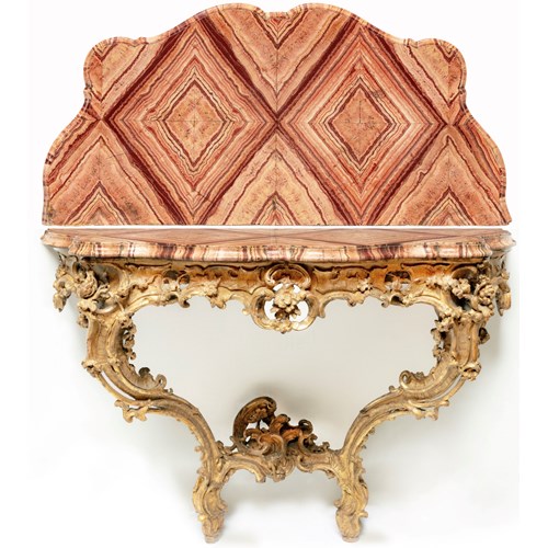 A Roman Rococò Carved Giltwood Console Table, with a serpentine veneered Pavonazzetto Romano marble top